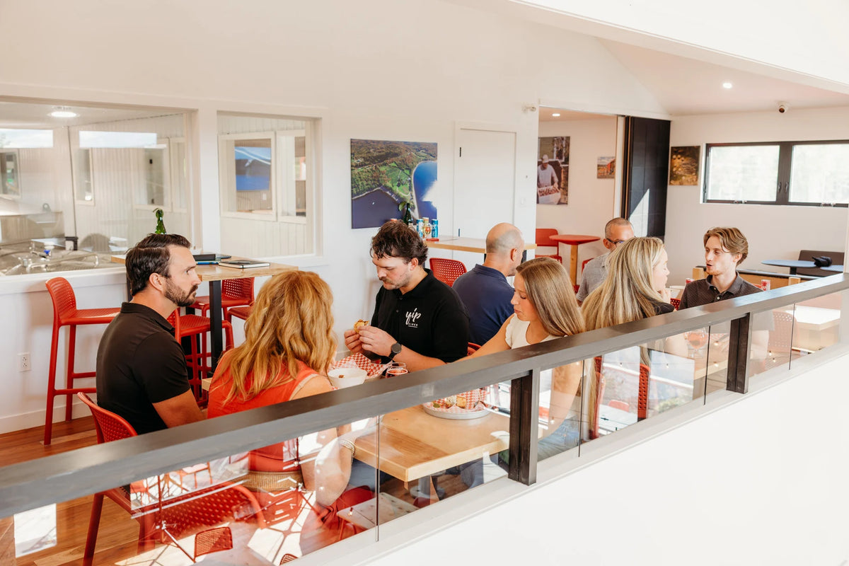 Guests gathered at tables in the bright adjoining Lounge, overlooking the Taproom