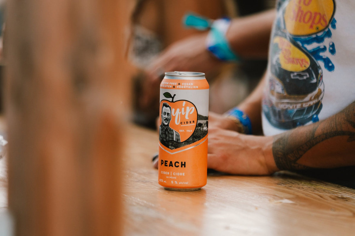 A can of Yip Peach standing on a wooden bar
